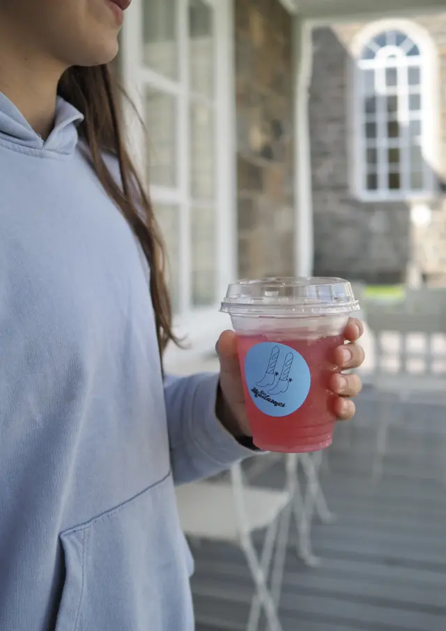 Jeune fille sur la galerie de chez Les Madames Café & Boulangerie à Saint-Bernard